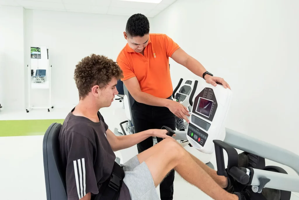 Therapist assists with Dyaco stepper