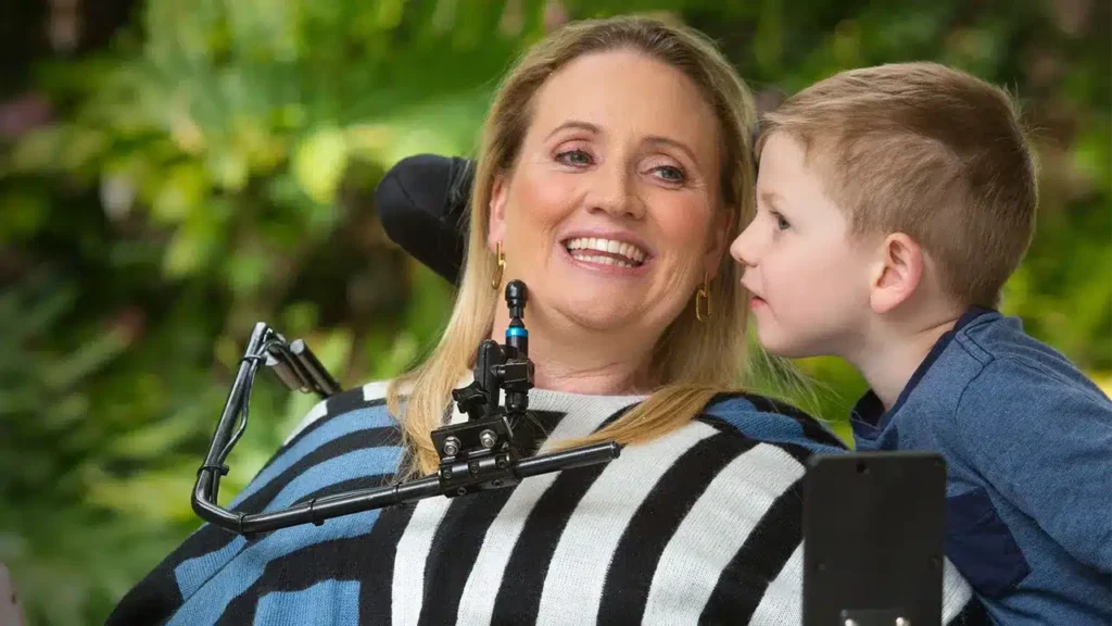 Smiling woman with young boy outdoors